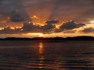 The sunsetting over the ocean.