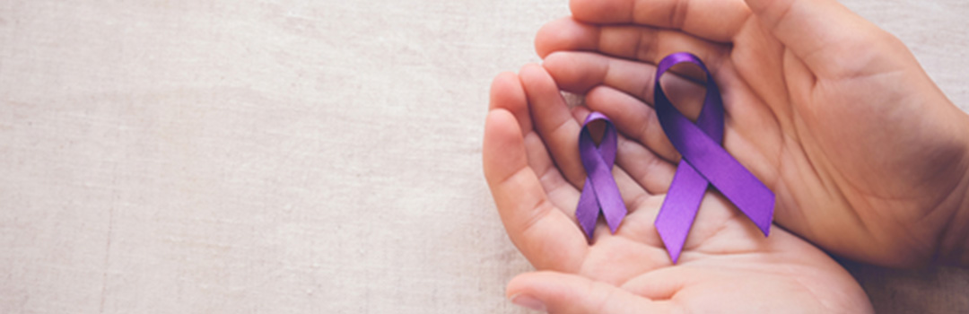 hands holding purple ribbon