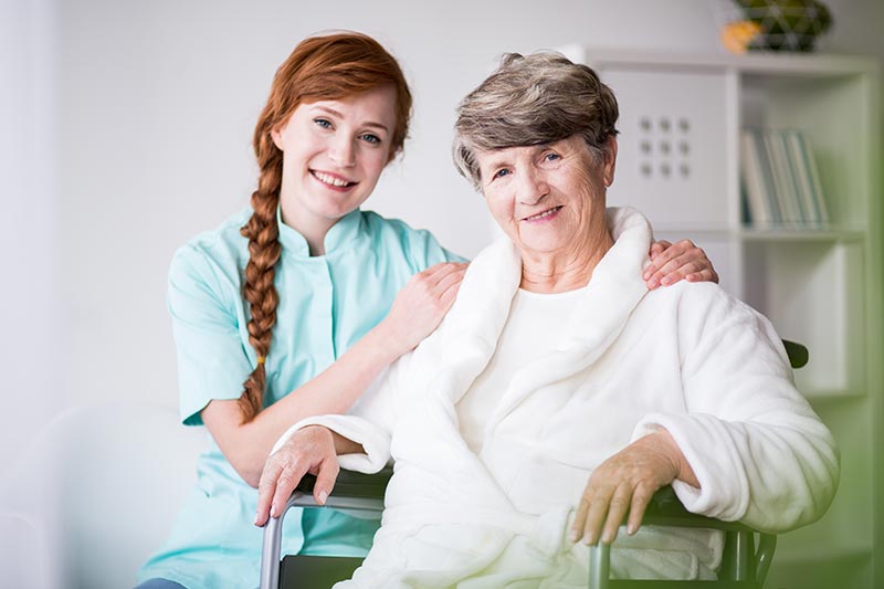 Caregiver Helping Senior in Wheelchair