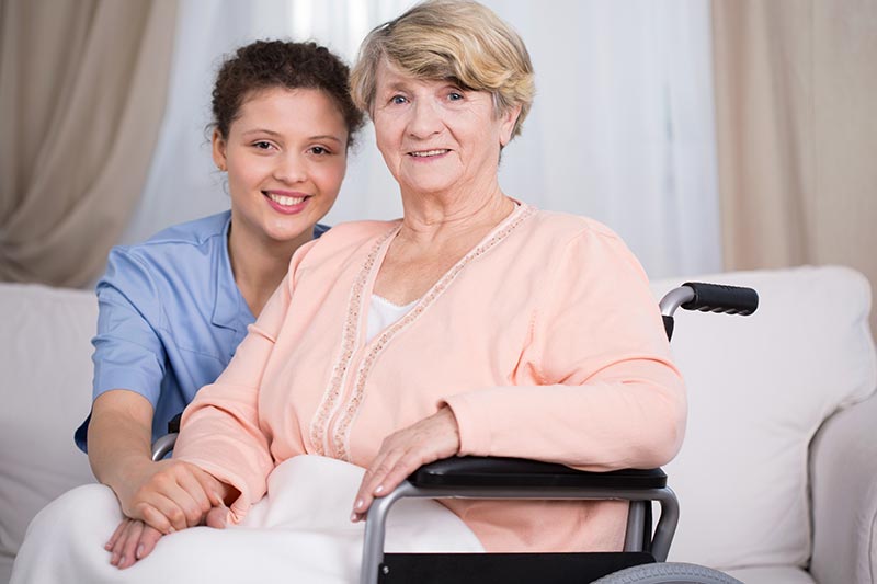 Caregiver Helping Senior in Wheelchair