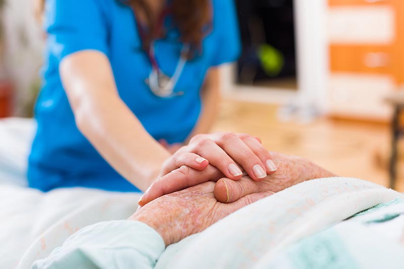 Caregiver holding seniors hand