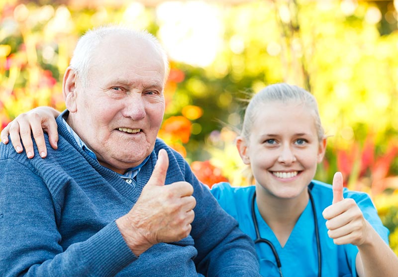 Senior with Caregiver thumbs up