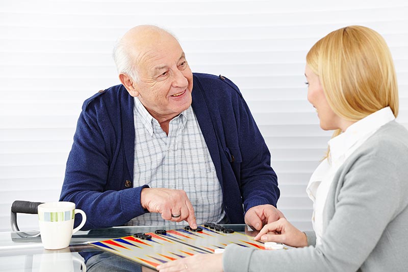 Senior and Caretaker playing game