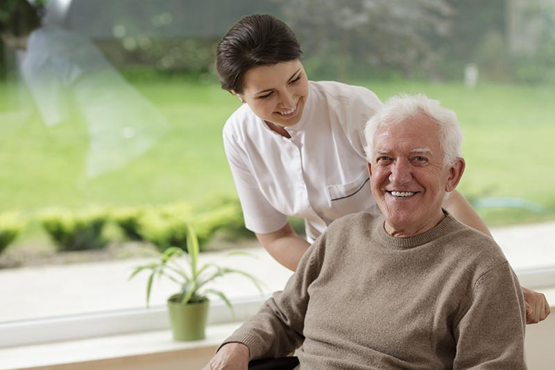 Senior in wheelchair with Caretaker