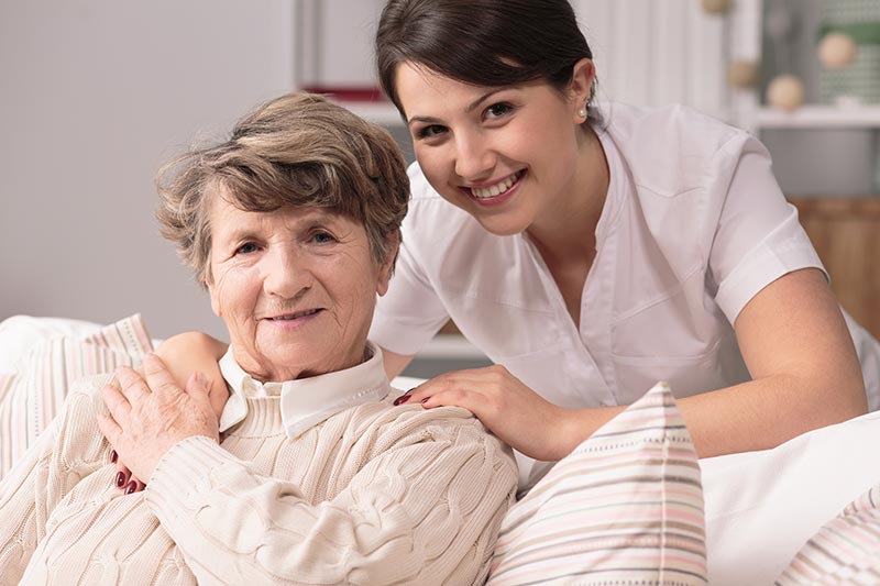 Senior Woman with Caregiver Helping