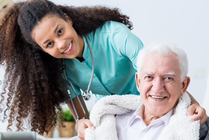Woman Medical In-home Caretaker with Senior Man