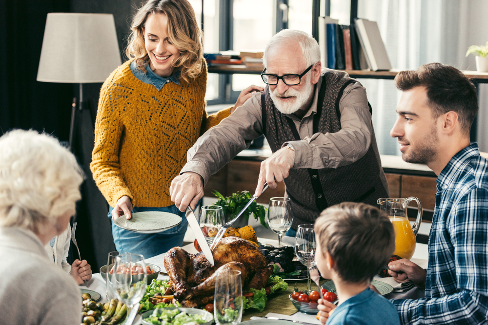 Grandparents and family gathered around the dining table for a holiday feast