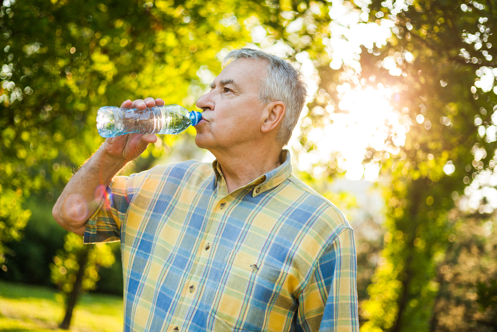 Senior Man, Is Drinking Water In Park.