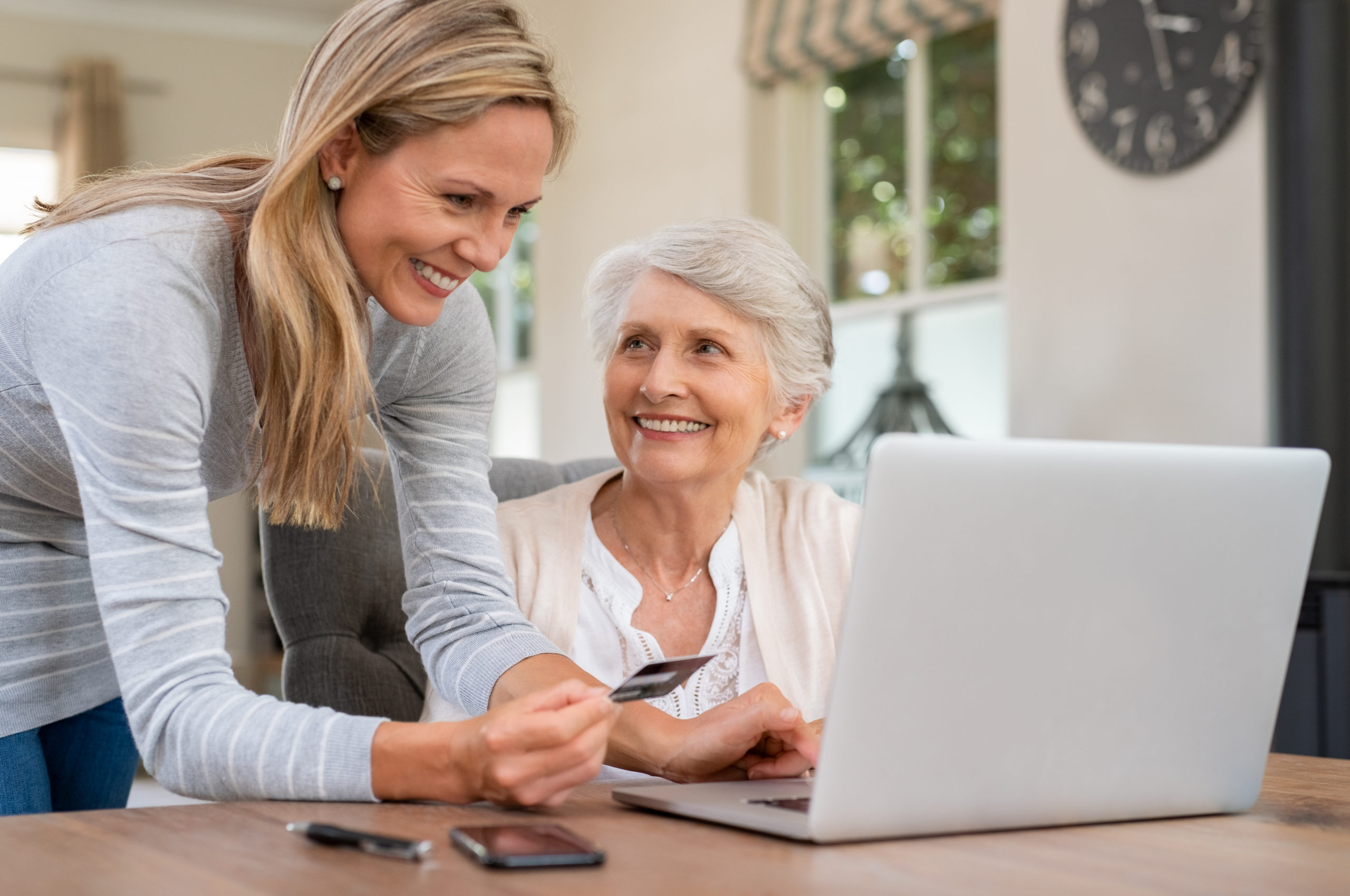Smiling Mature Woman Making Payment Via Credit Card For Shopping