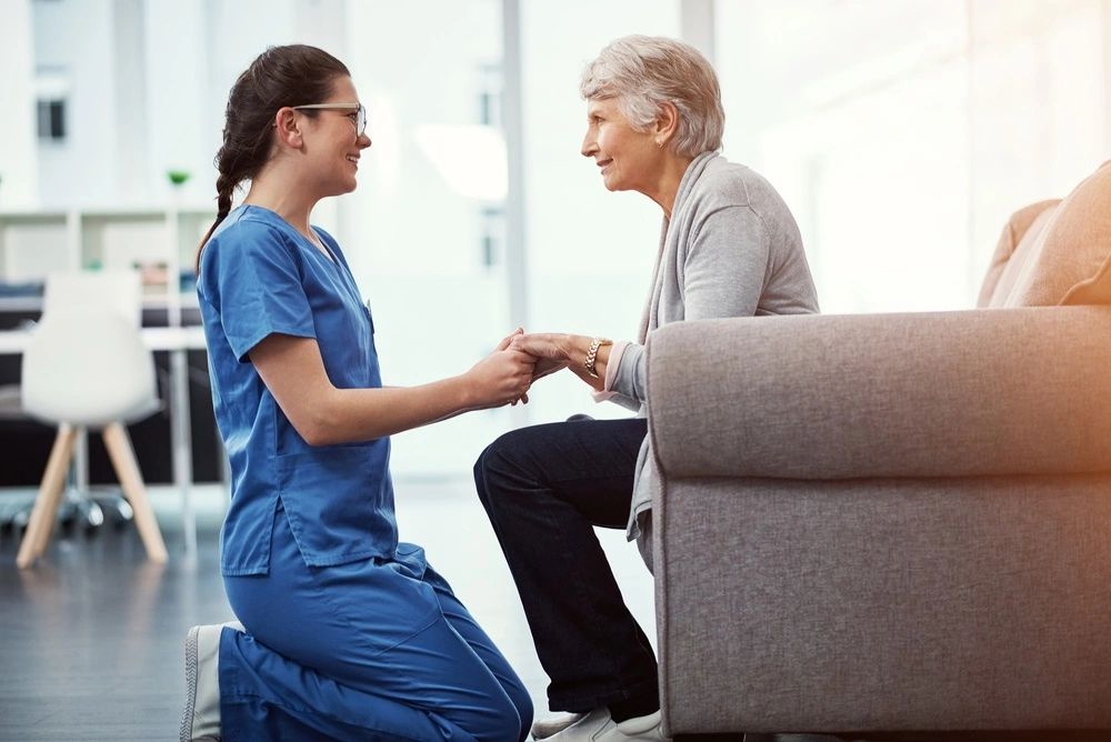 Caregiver holding patient's hand