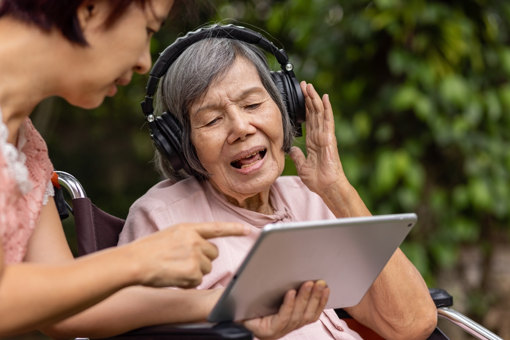 Senior woman singing along to music therapy